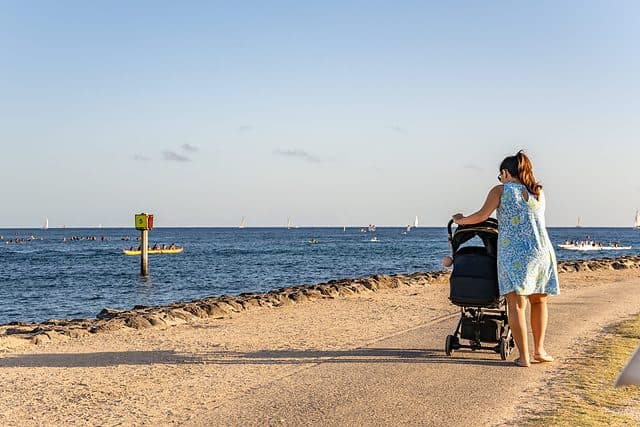 mom with baby stroller on Oahu beachwalk