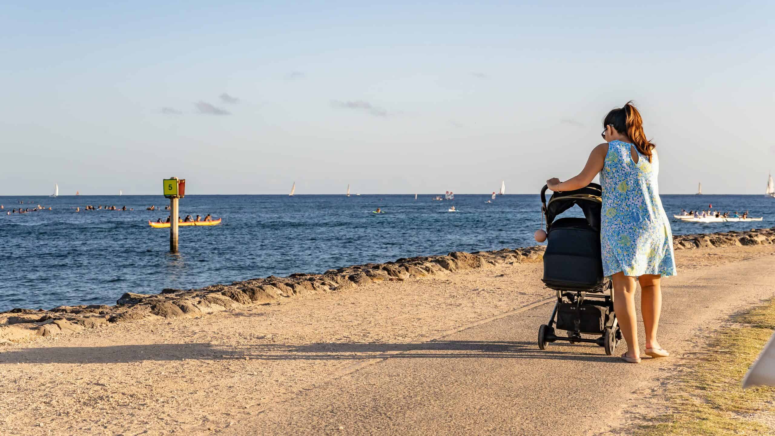 mom with baby stroller on Oahu beachwalk