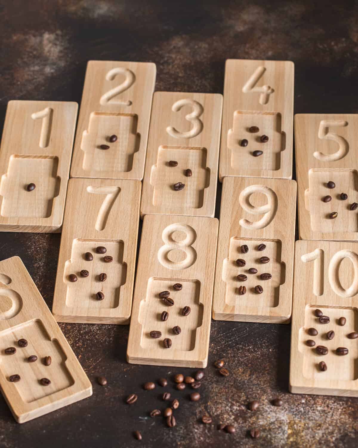 Wooden counting and writing trays with coffee beans for educating littles on number writing, fine motor skills, hand eye coordination, mathematical skills. Montessori materials. Counting math game