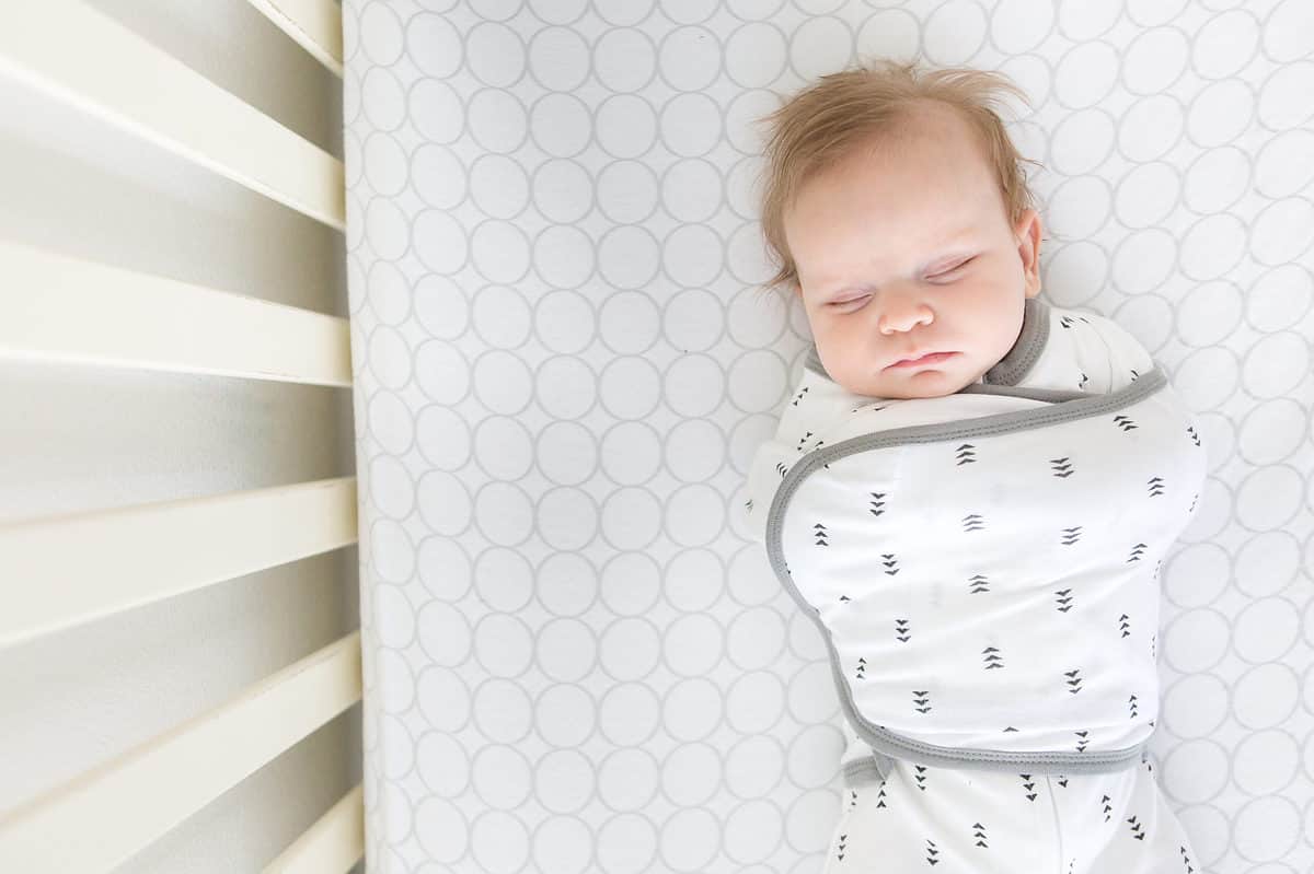 baby sleeping in a swaddling blanket