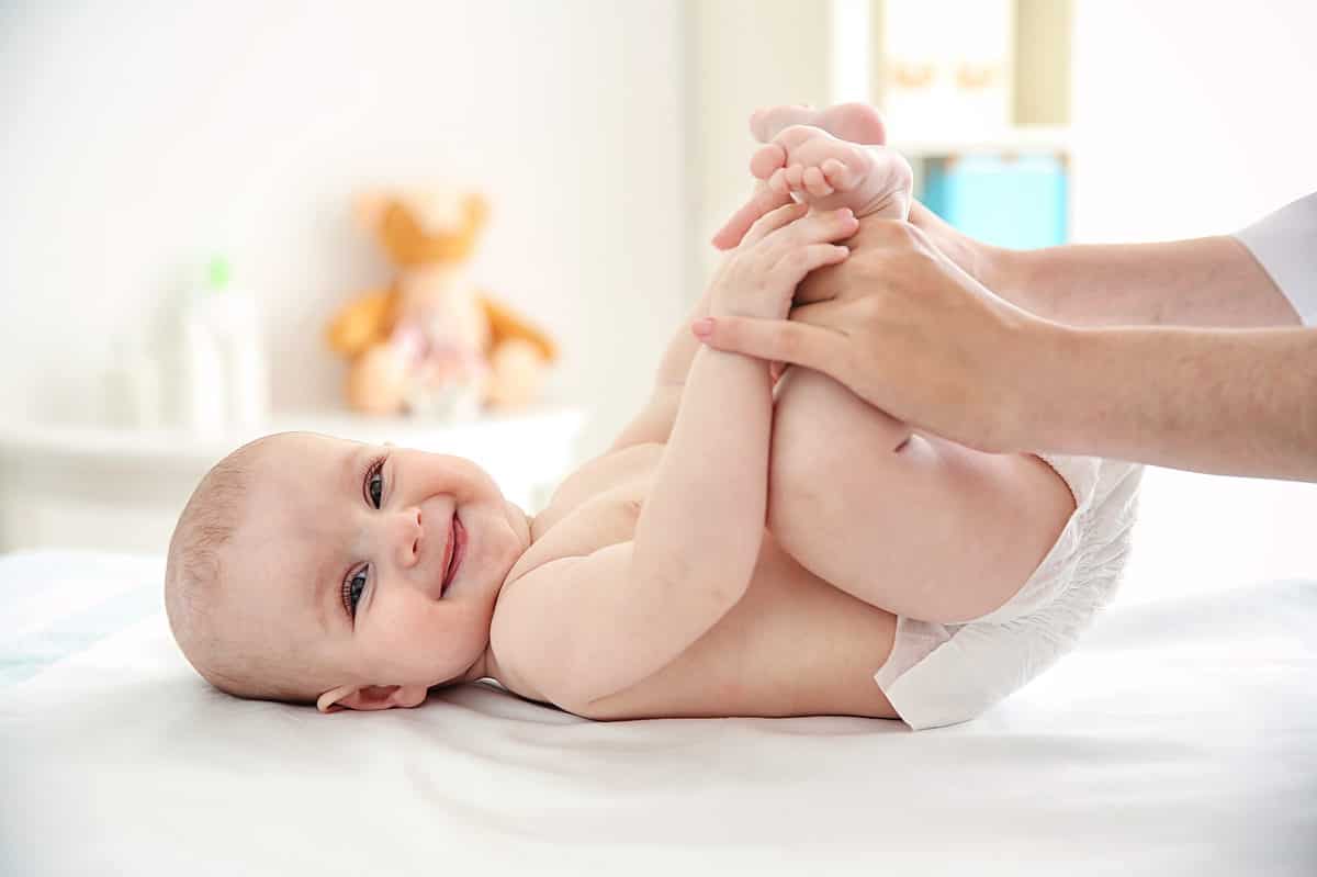 happy baby getting diaper change