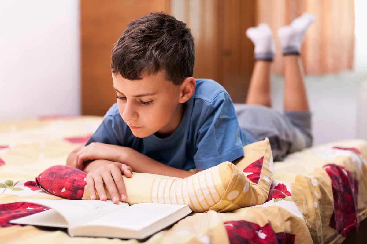 Child reading in bed