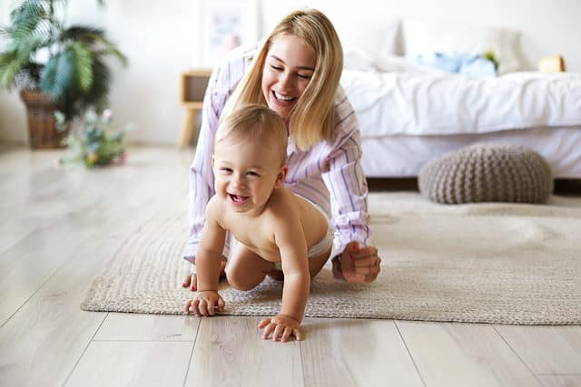 mom crawling on floor with baby