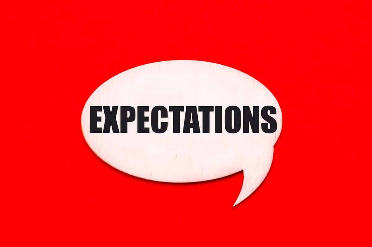 A white speech bubble with the word EXPECTATIONS in black,,against red isolate.