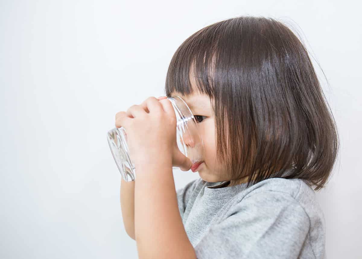 toddler drinking from open cup