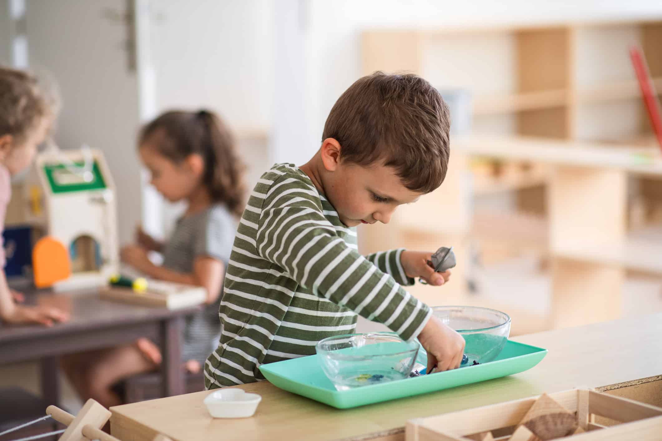 Young student is busy with an activity in a Montessori classroom.