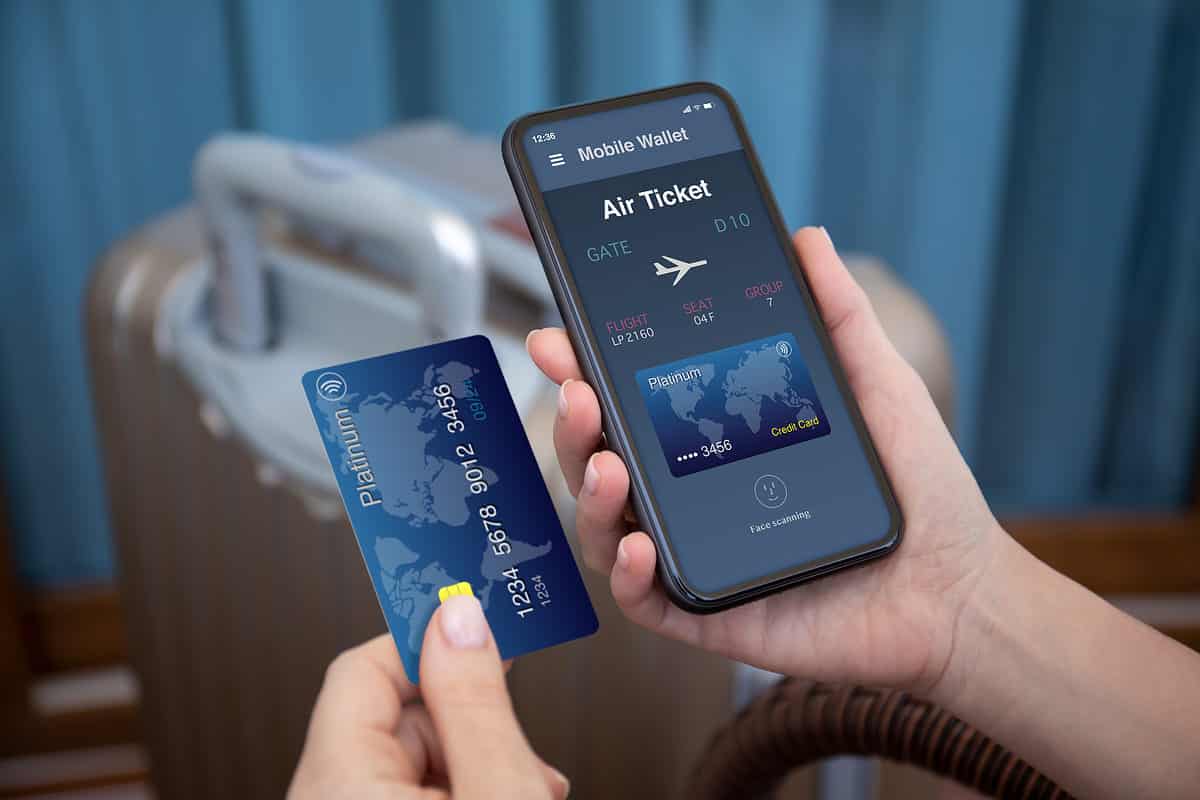 female hands hold phone airplane ticket application airlines credit card