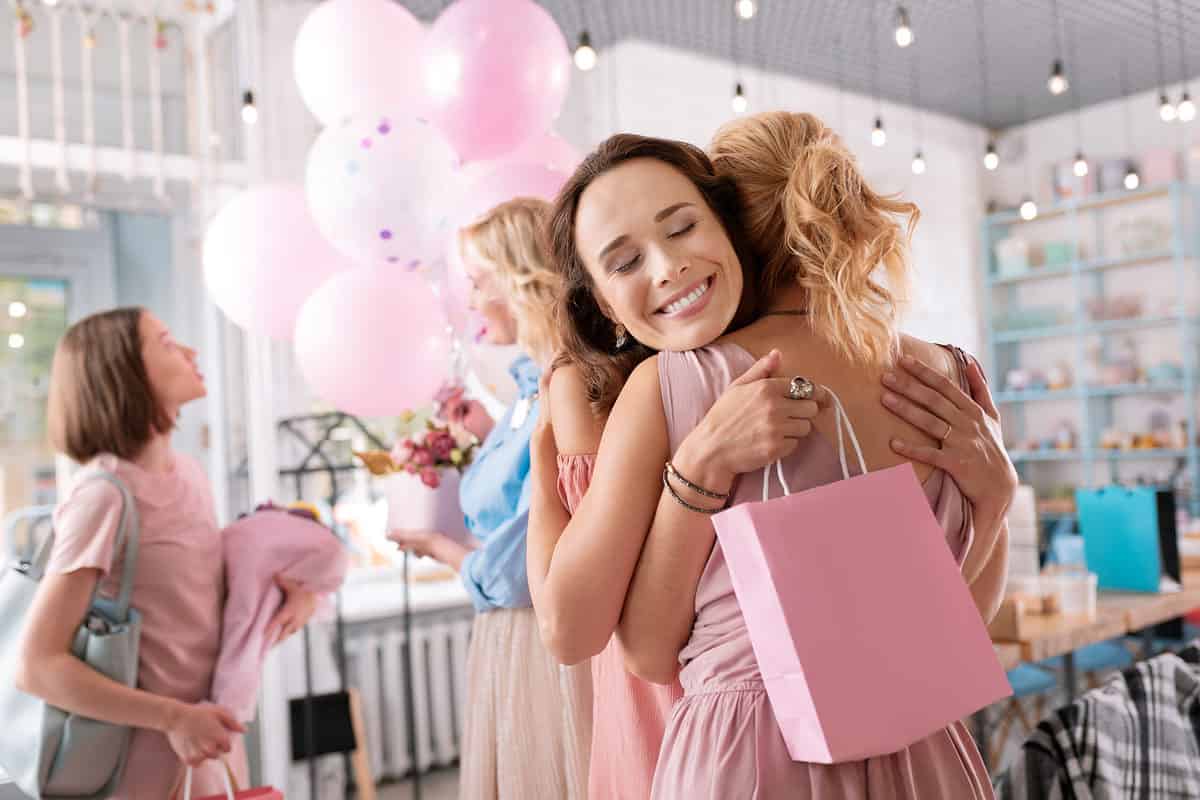 Women hugging at baby shower