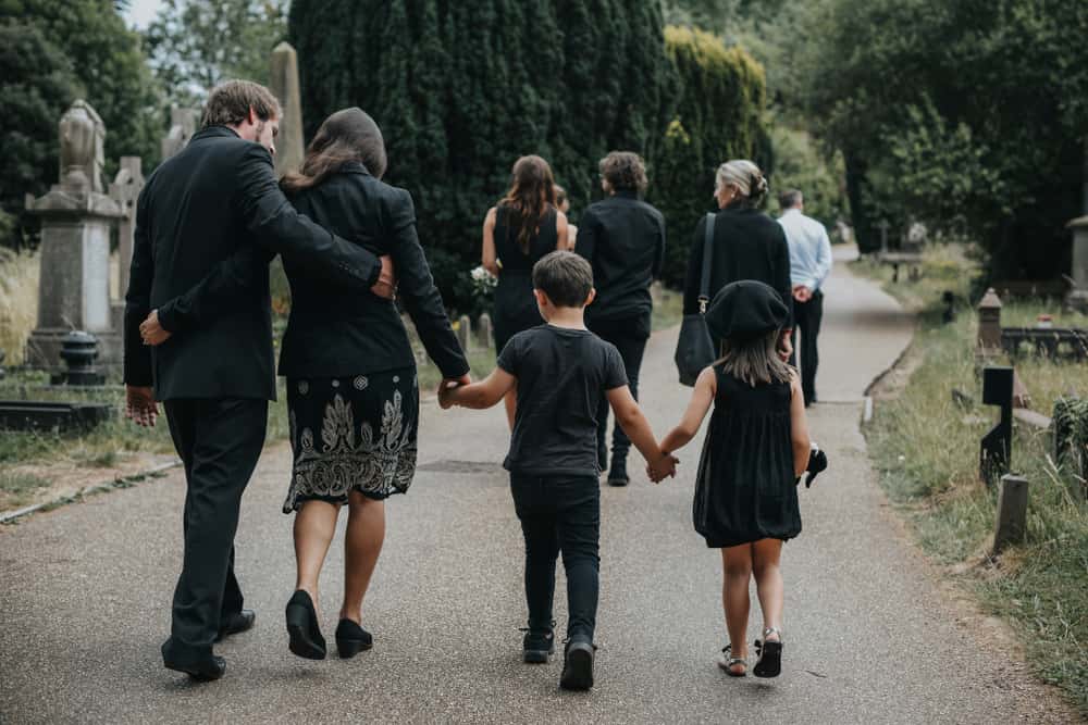 Family with kids at a funeral