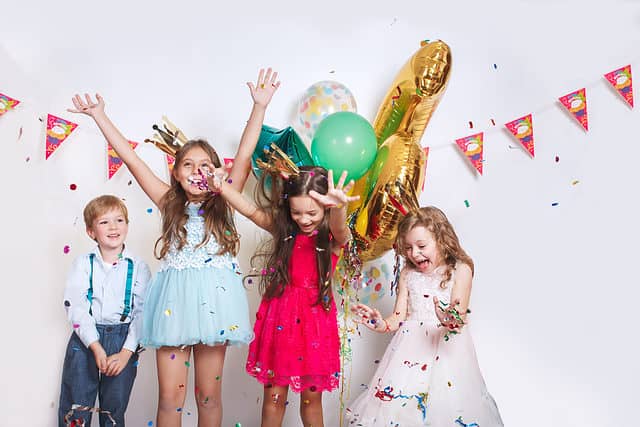 Group,Of,Kids,Throwing,Colorful,Confetti,And,Looking,Happy,On