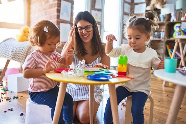 Teacher works with preschool students