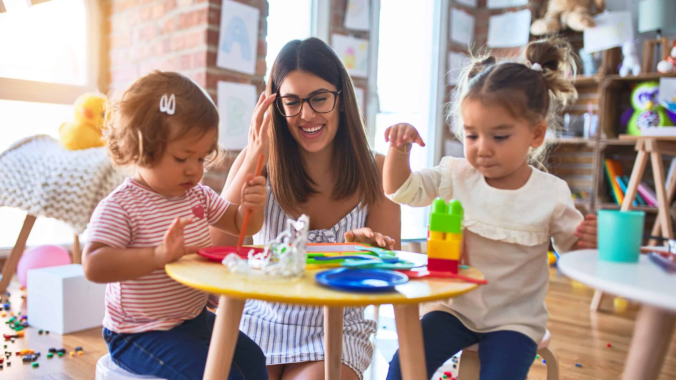 Teacher works with preschool students