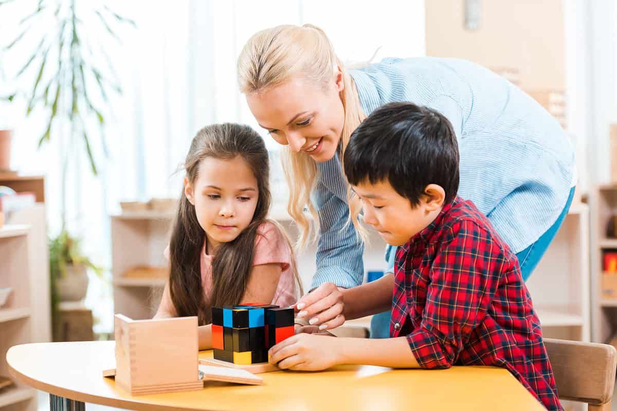 Montessori teacher with two students