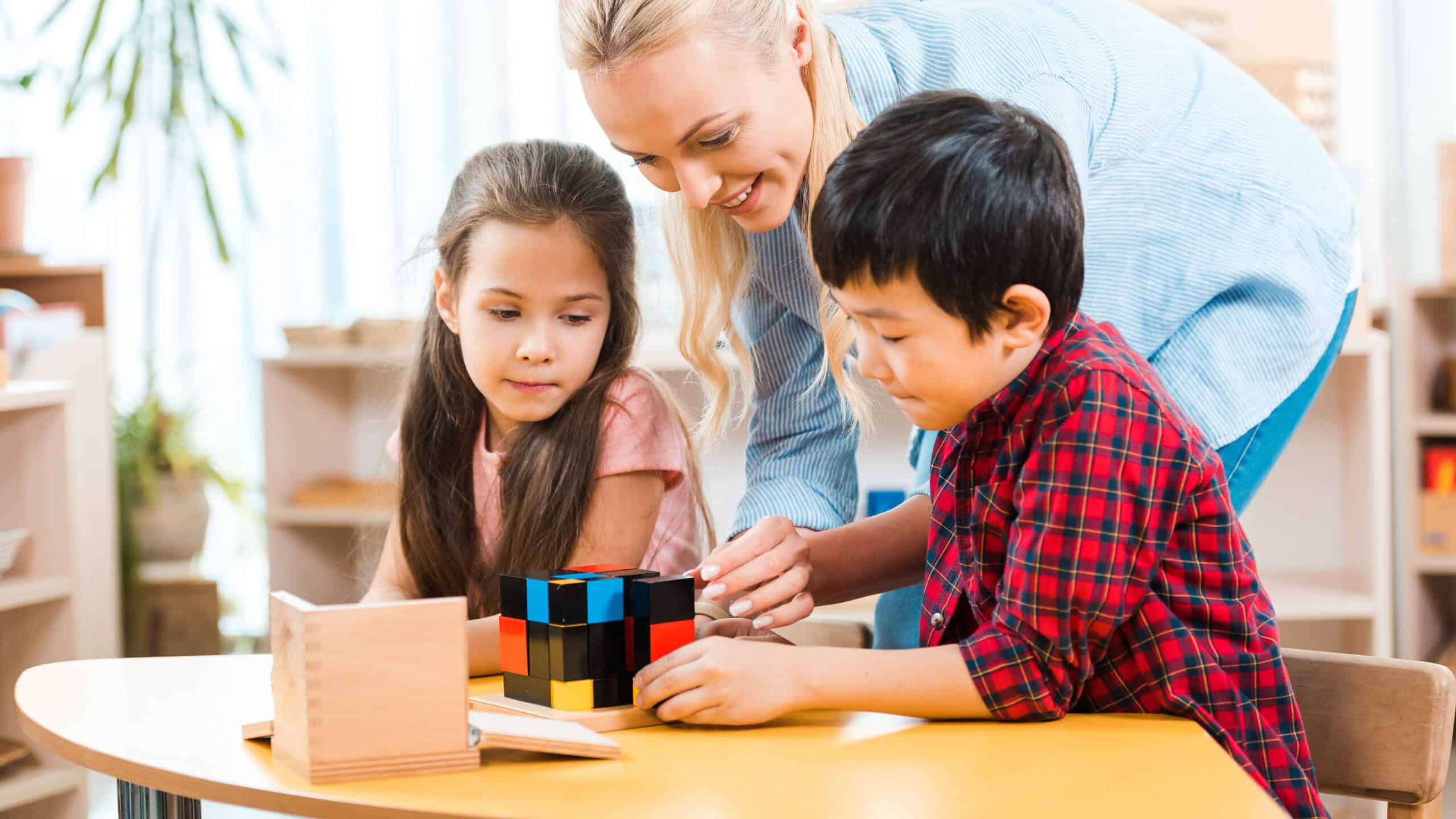 Montessori teacher with two students