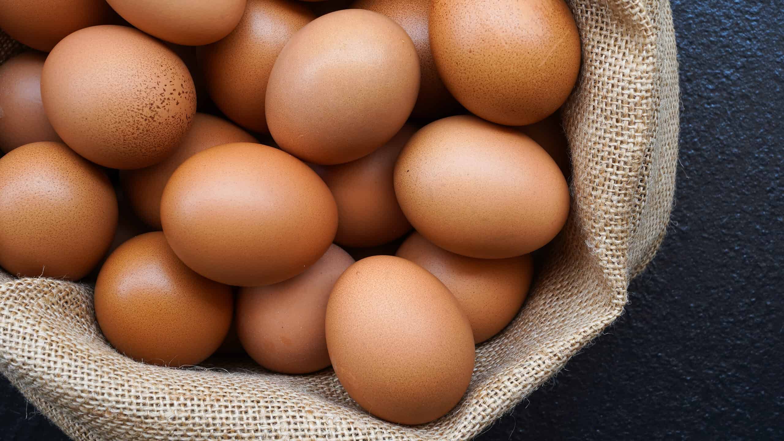 Chicken,Eggs,In,Sack,Bag,On,Black,Background.