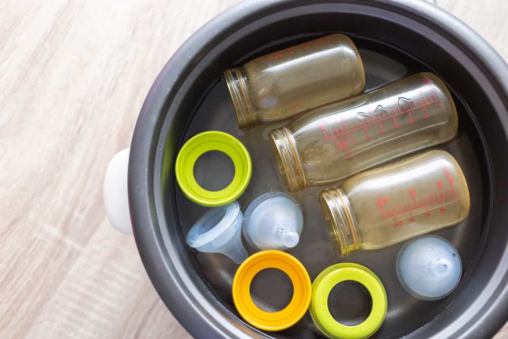 Baby bottles in a pan of water