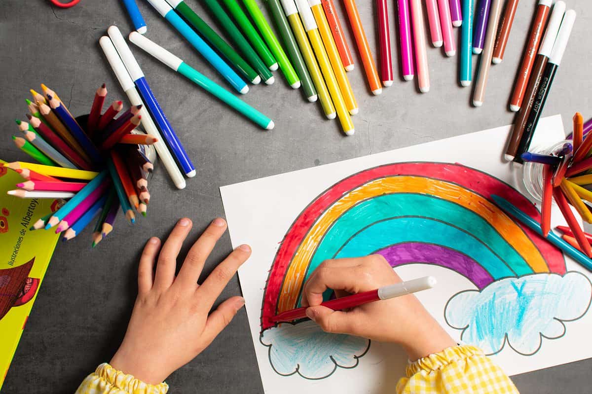 Child drawing a rainbow