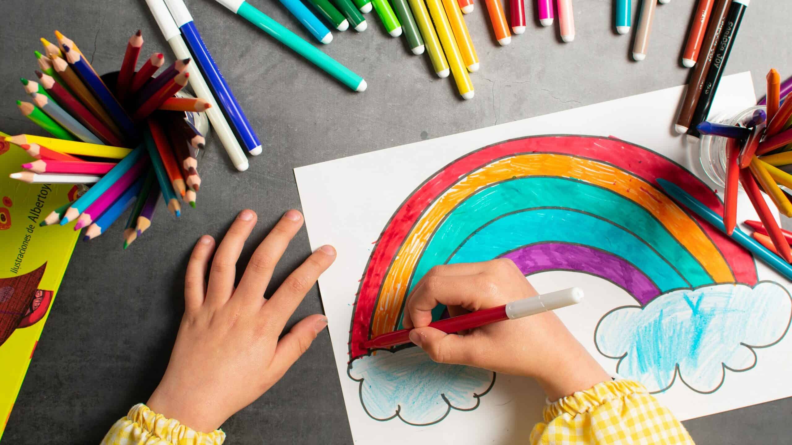 Child drawing a rainbow