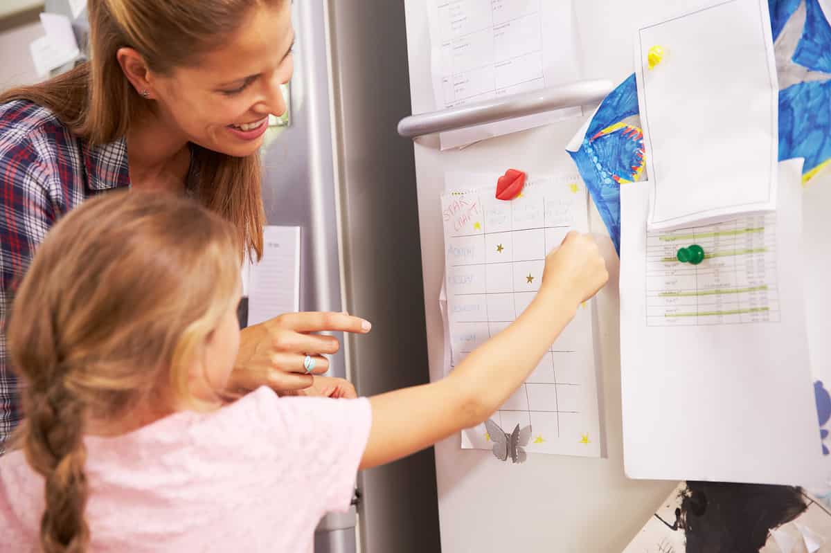 Mother and child with behavior chart