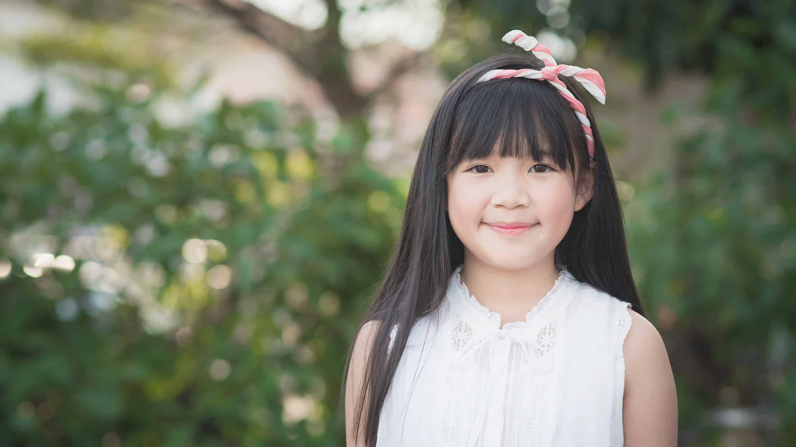 Happy little asian girl having fun at the park