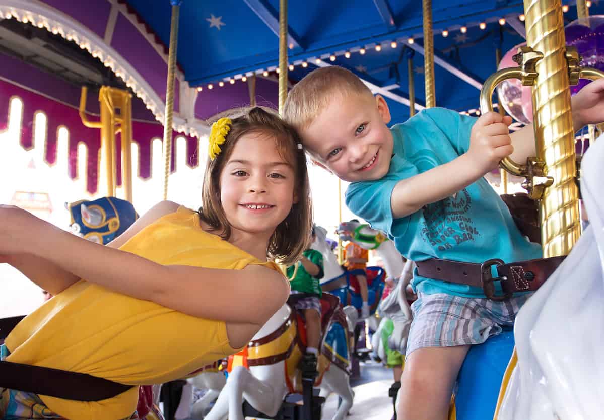 Kids,Having,Fun,On,A,Carnival,Carousel