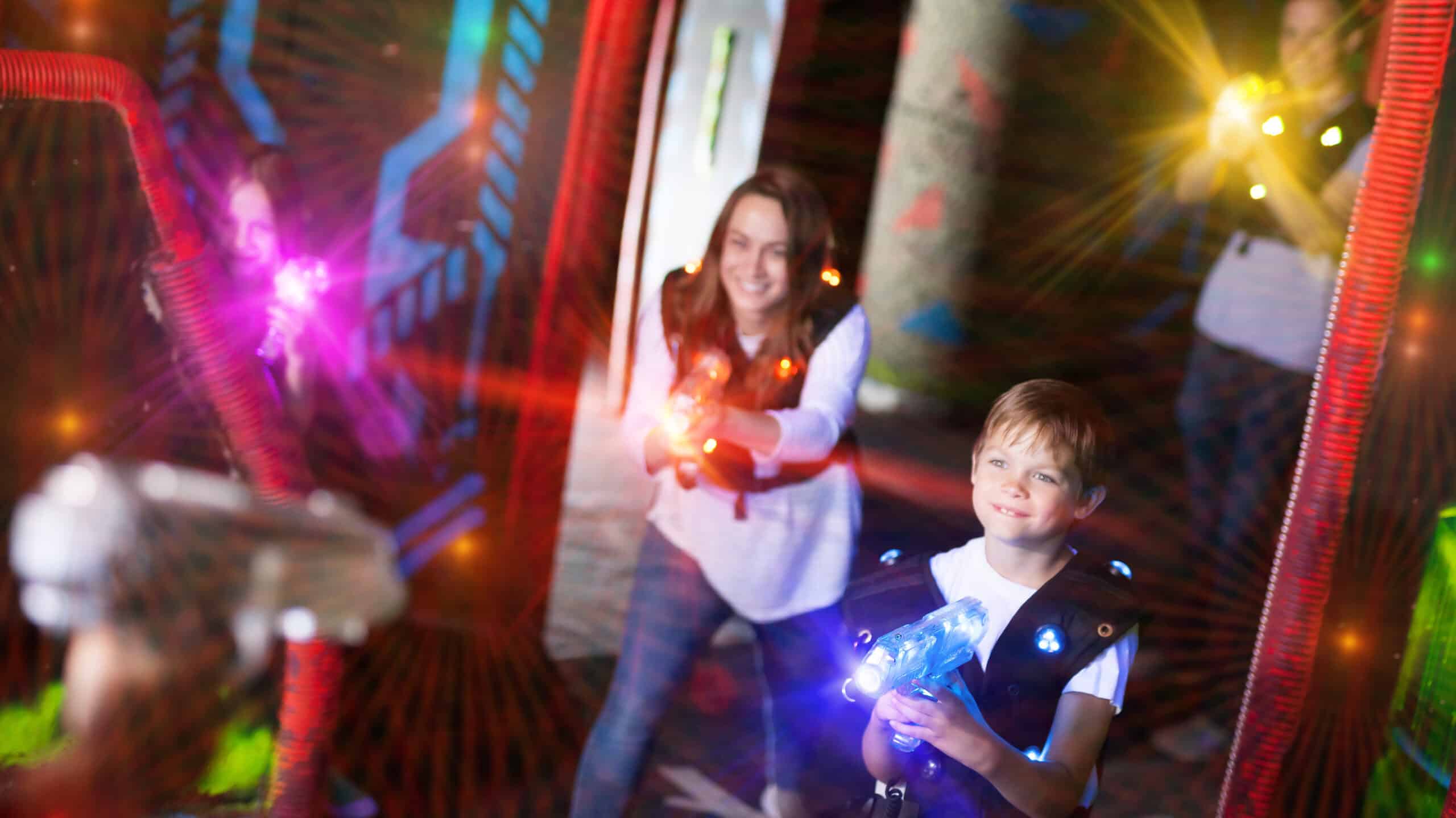 Excited,Kids,And,Theirs,Parents,In,Bright,Beams,Of,Laser