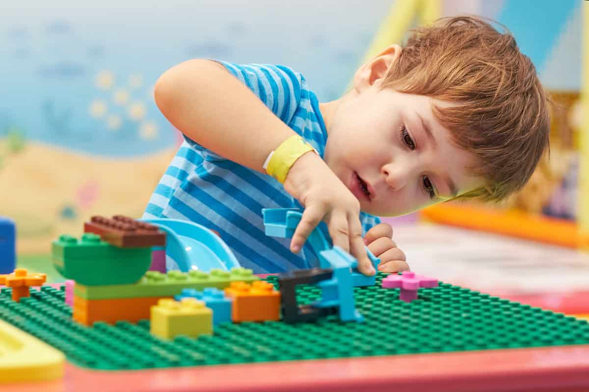 Child,Playing,And,Building,With,Colorful,Plastic,Bricks,Table.,Early