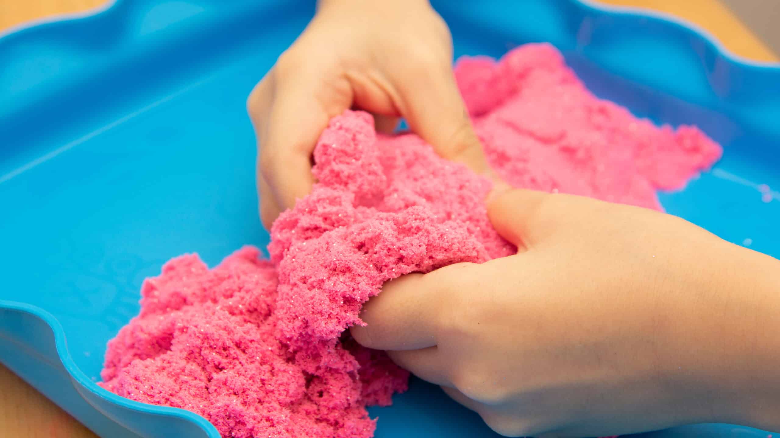 Child playing with Kinetic Sand