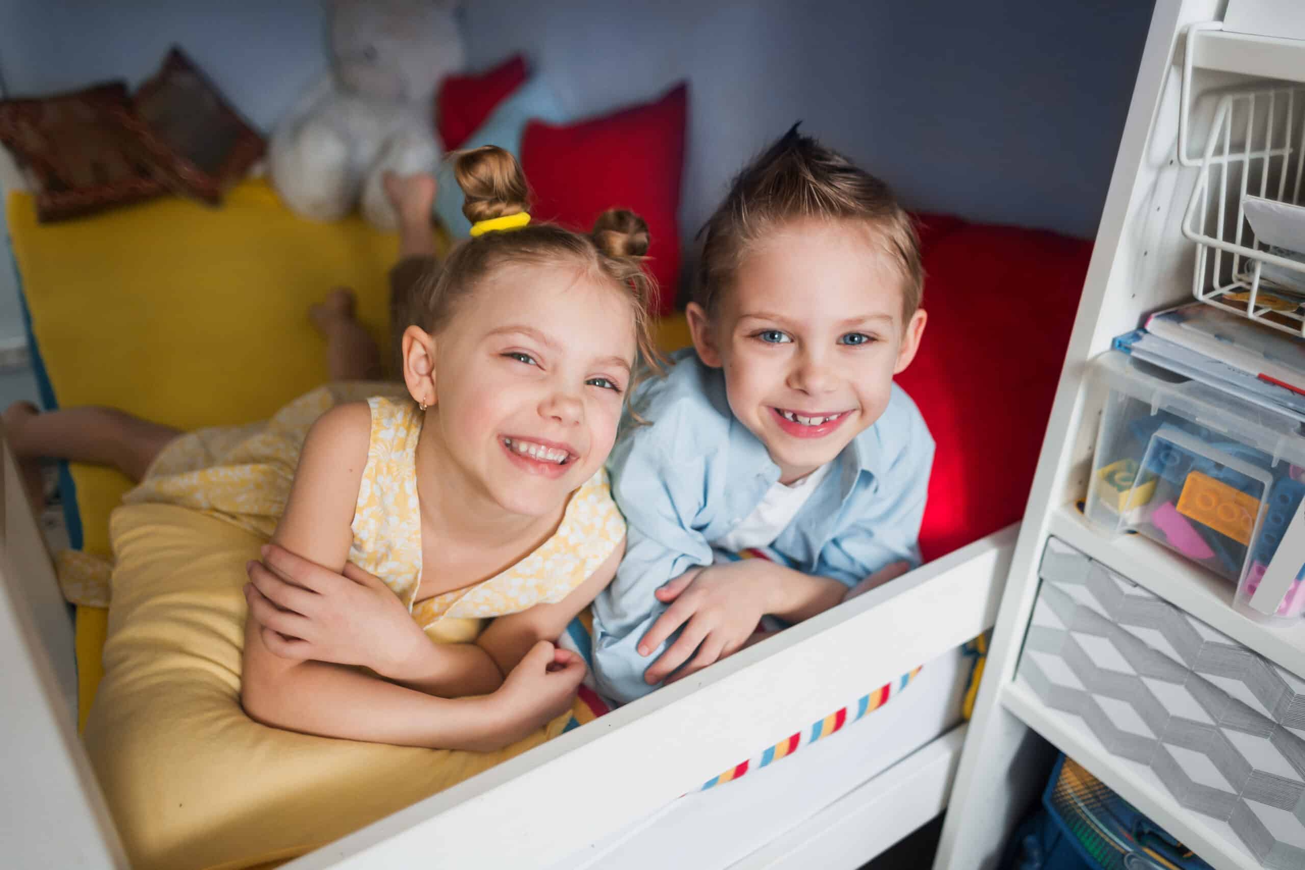 Two children in a loft bed