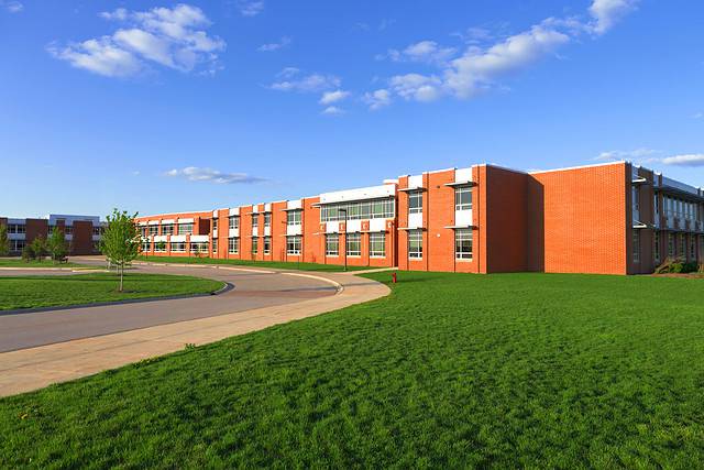 modern school building with a lawn