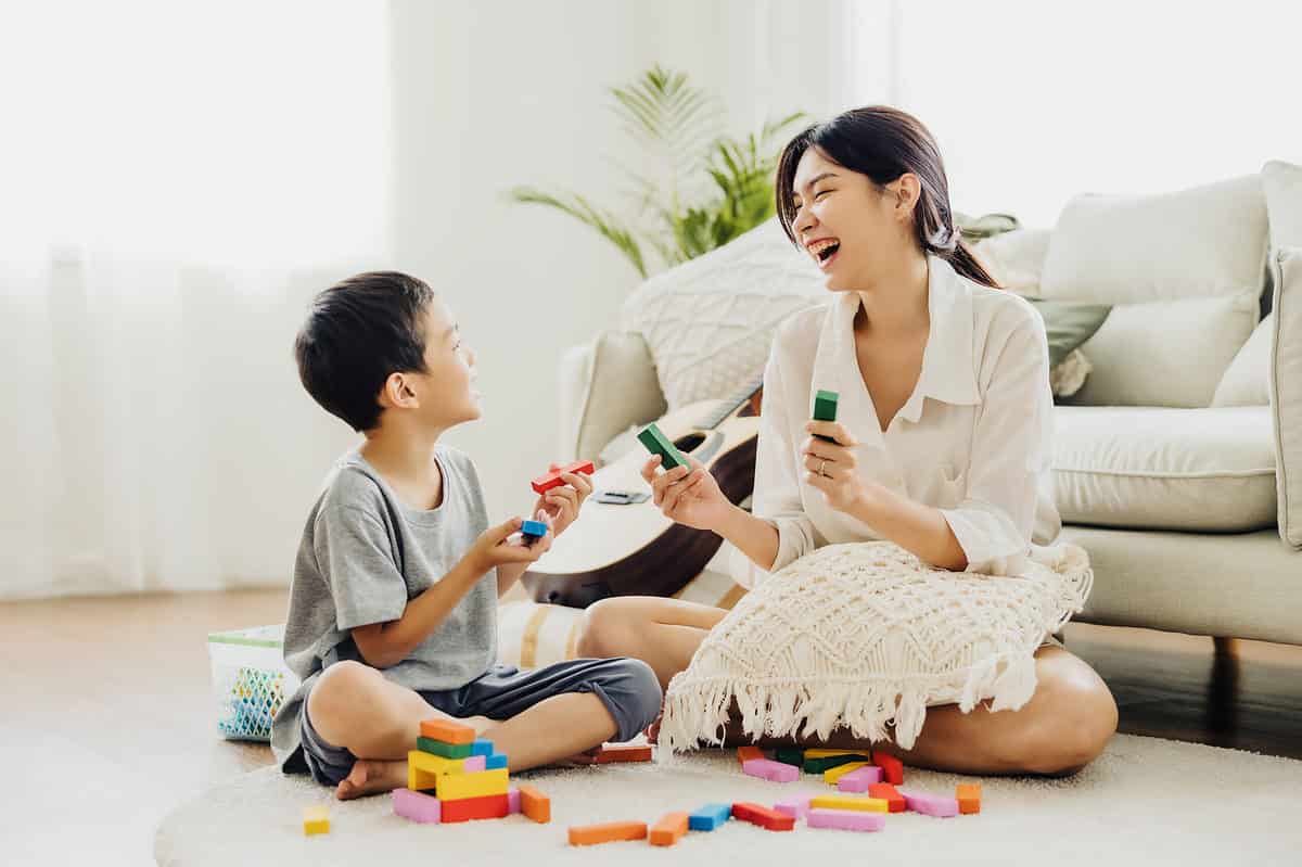 woman and child playing with blocks