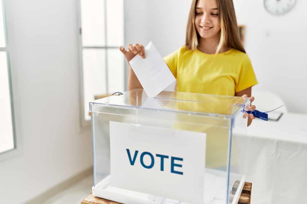Girl happily casting her ballot