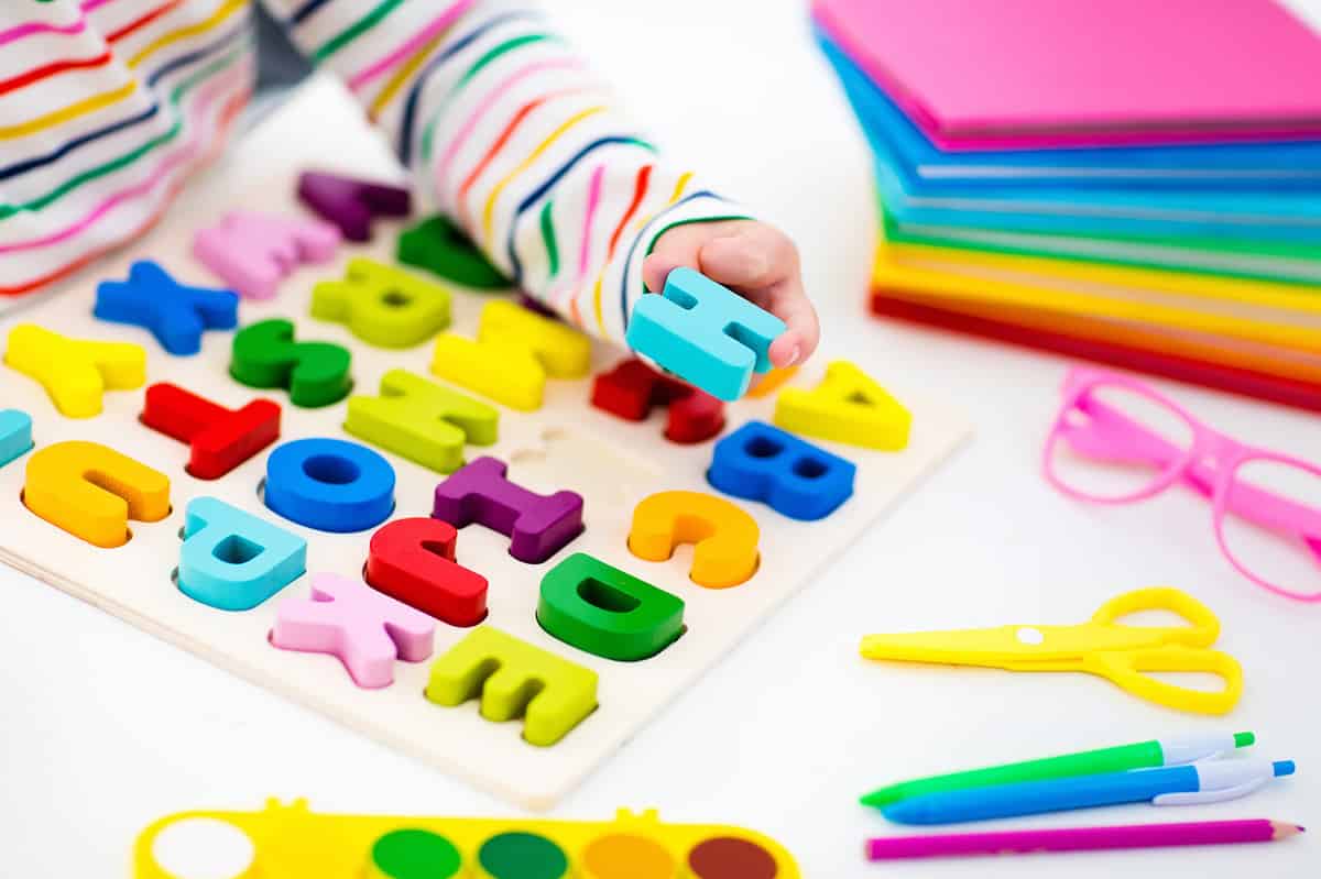 Child with colorful alphabet puzzle