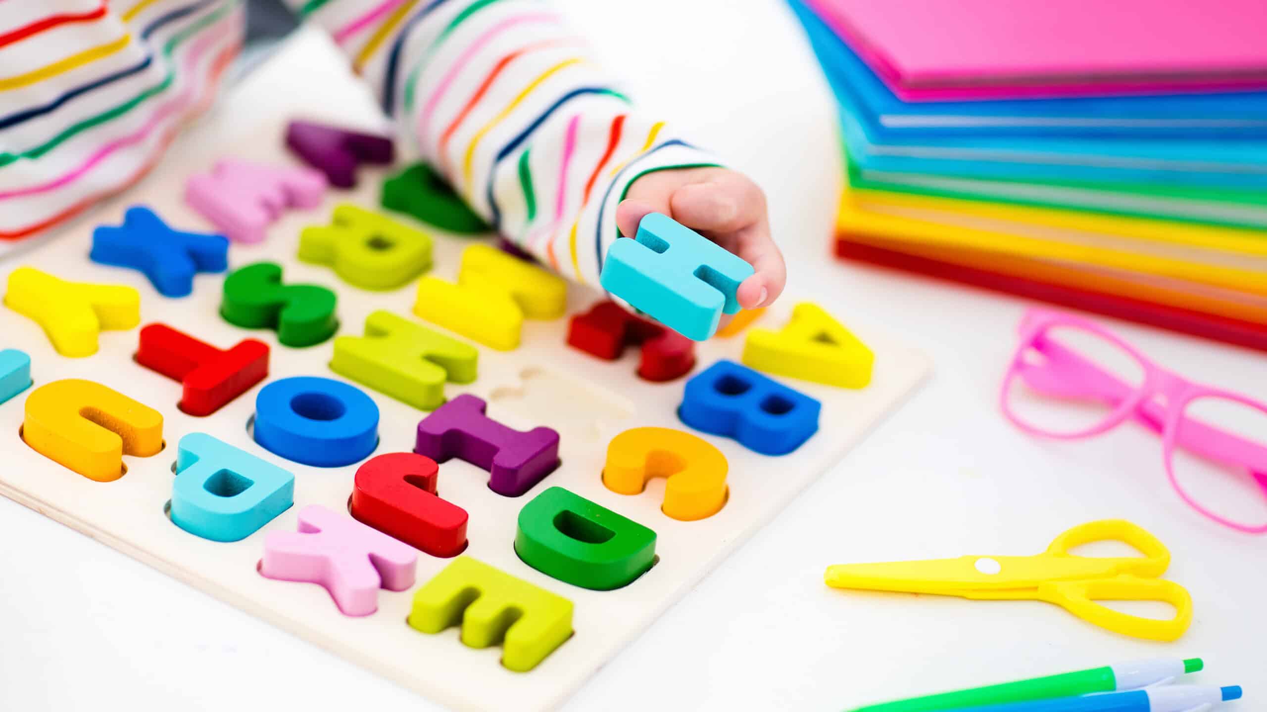 Child with colorful alphabet puzzle