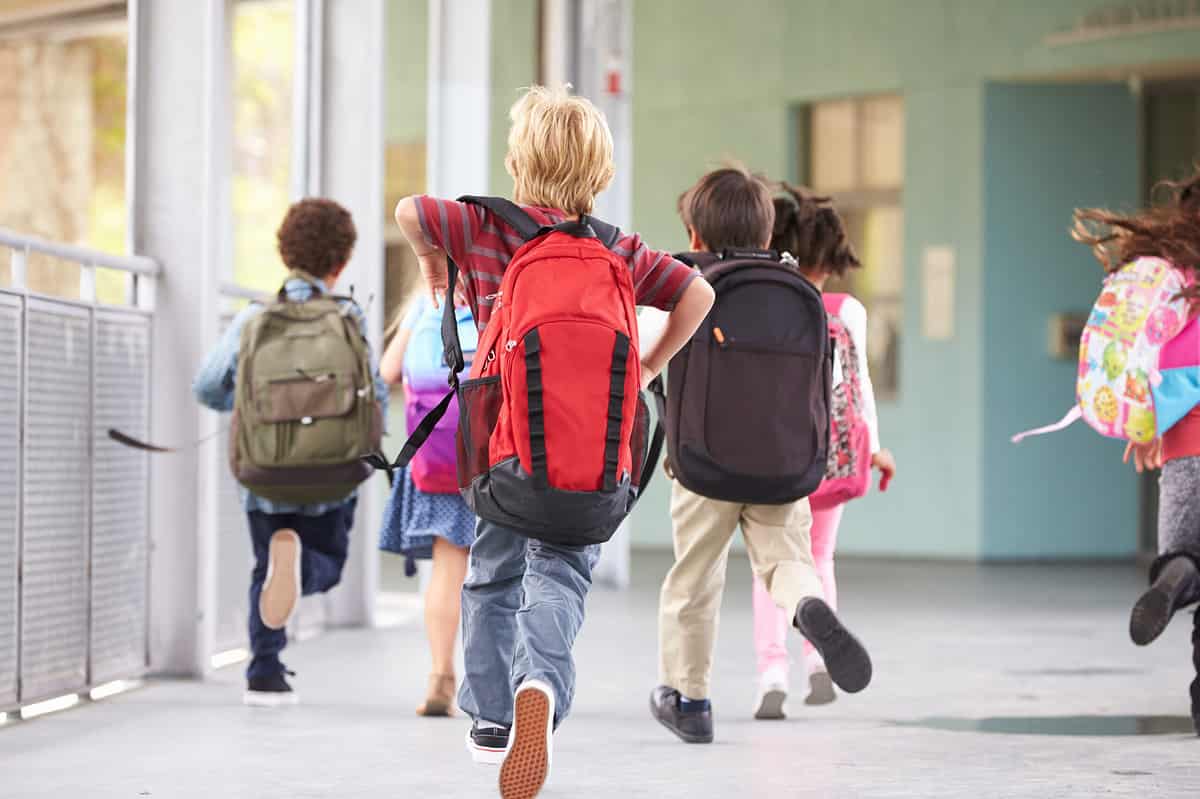 Elementary pupils running in the corridor of Capitol School of Austin