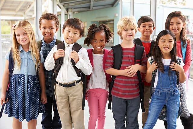 Group portrait of elementary school kids in school corridor