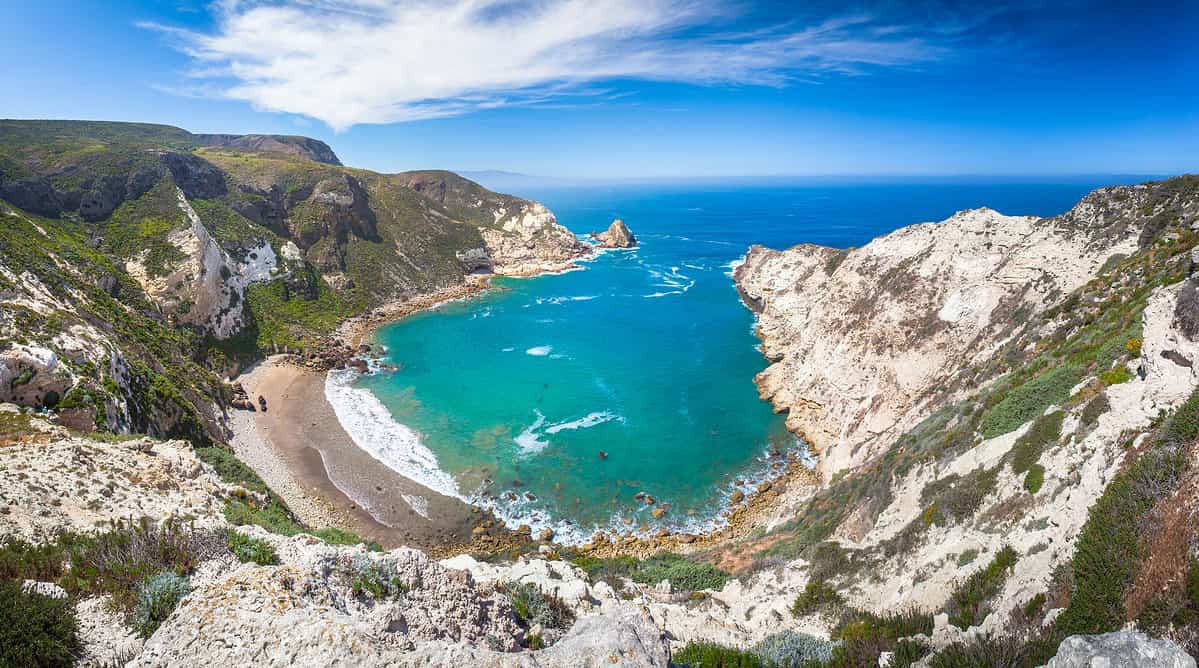 A panoramic photo of Potato Harbor, an oblong cove on the western side of Santa Cruz Island, California in National Park Service land, viewed from the cliffs above. Channel Islands National Park.