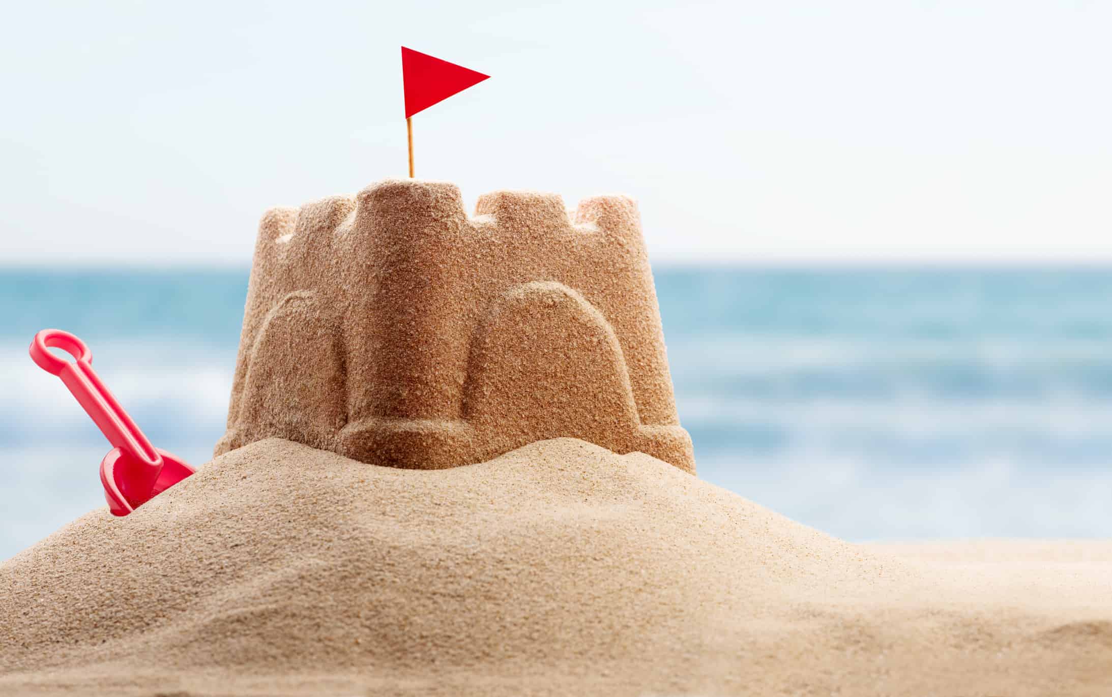 Holiday concept with sandcastle on the seaside