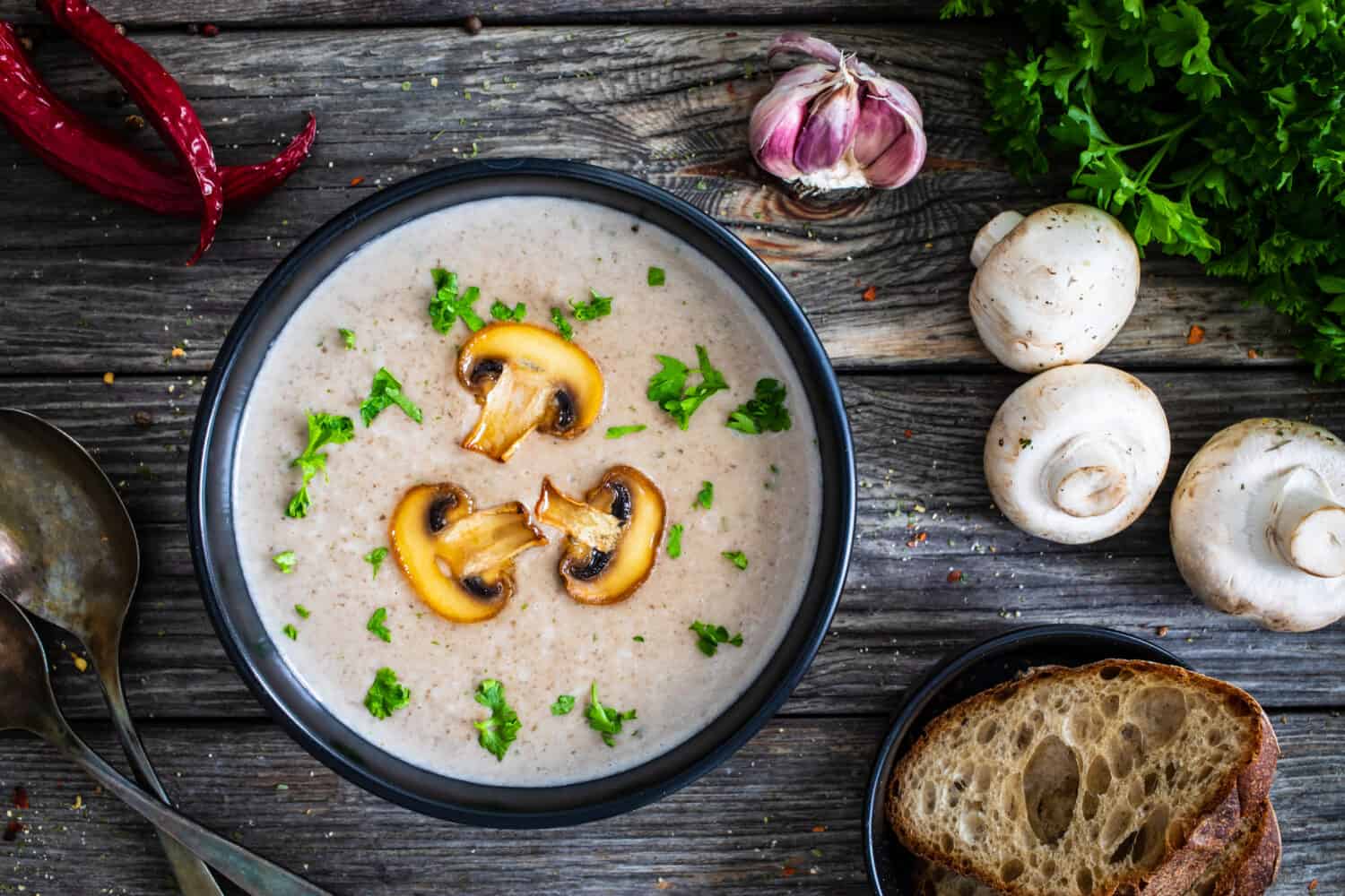 Cream of mushroom soup on wooden table 