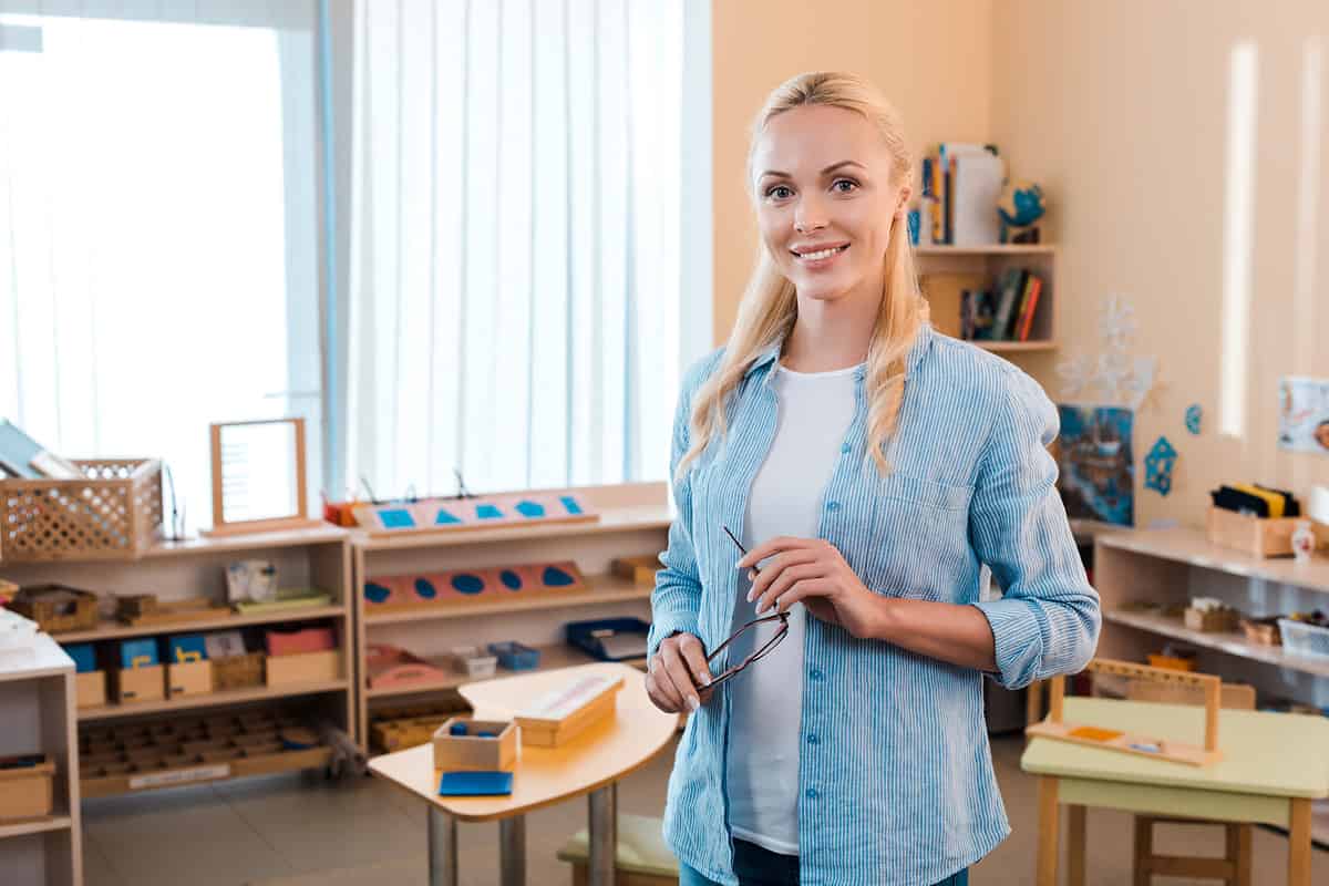 Montessori school teacher smiling in a Montessori classroom