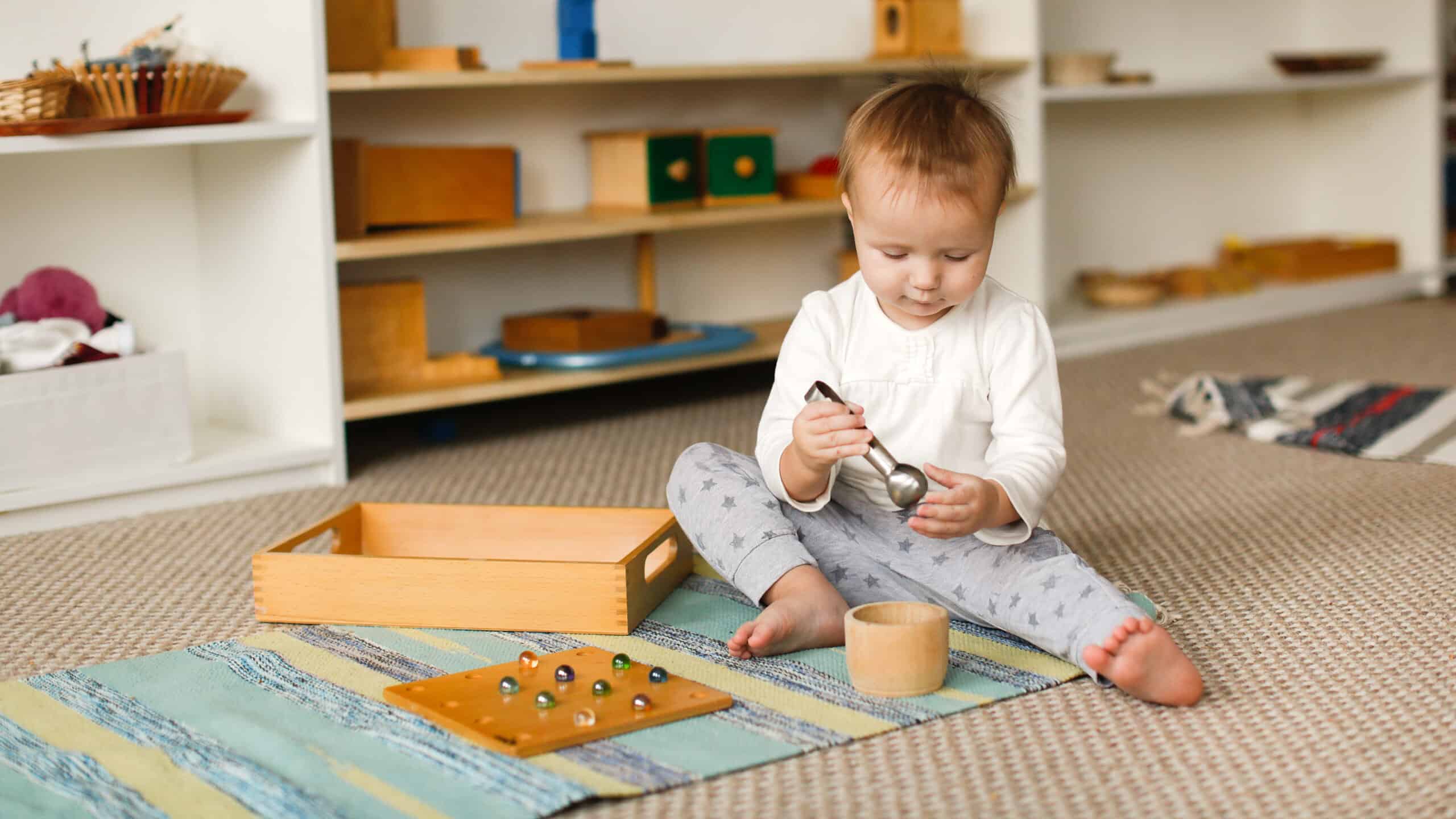 child playing next to a Montessori bookshelf