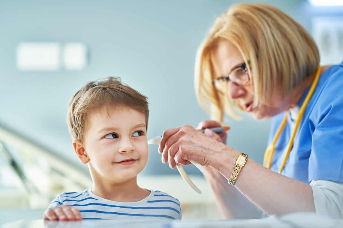 Doctor examining a child's ear