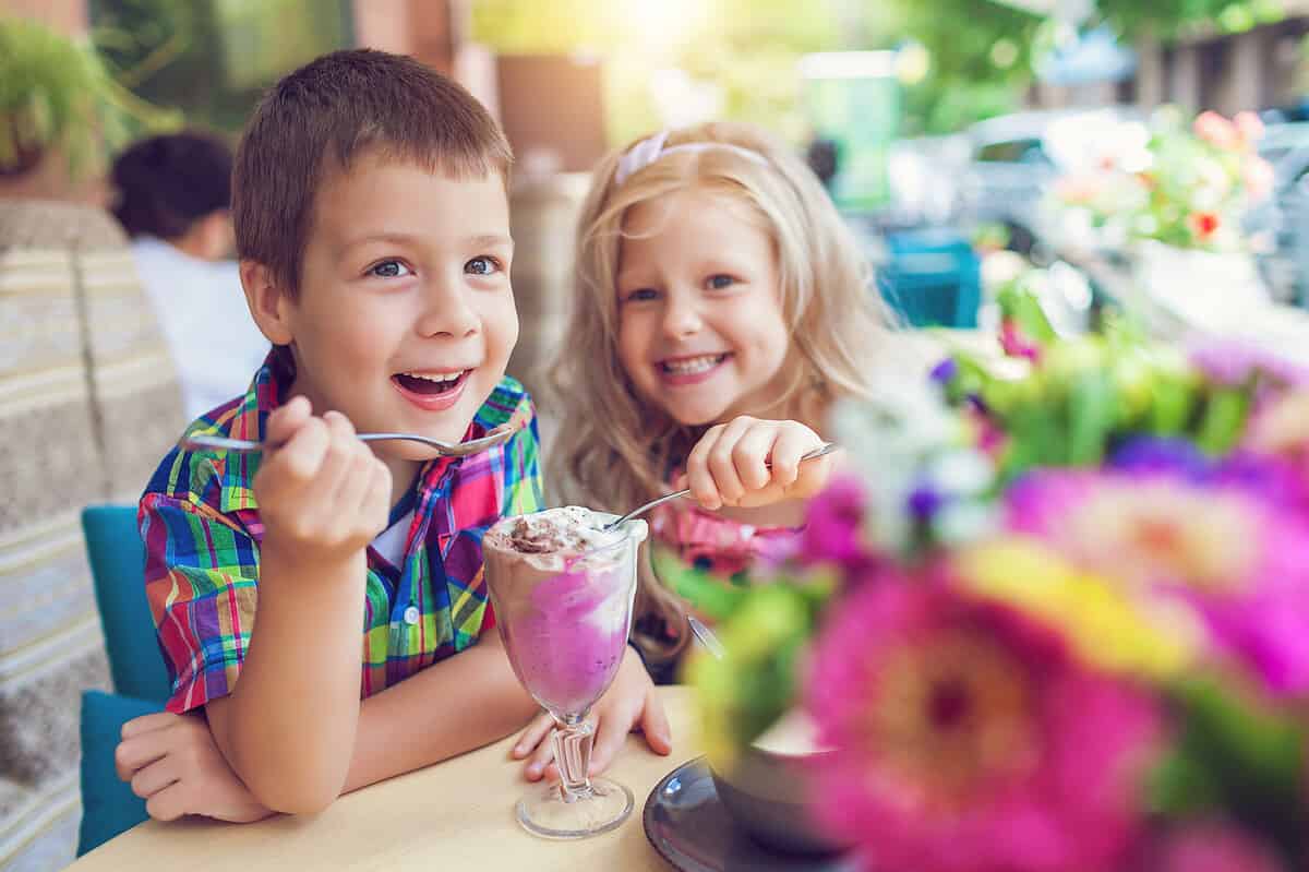 Little,Boy,With,A,Girl,Eating,Ice,Cream,At,An