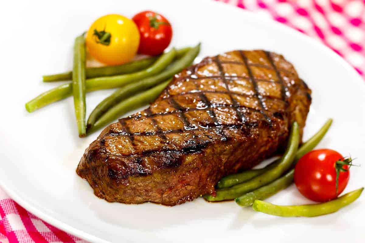 New york strip steak cooked and served with vegetables