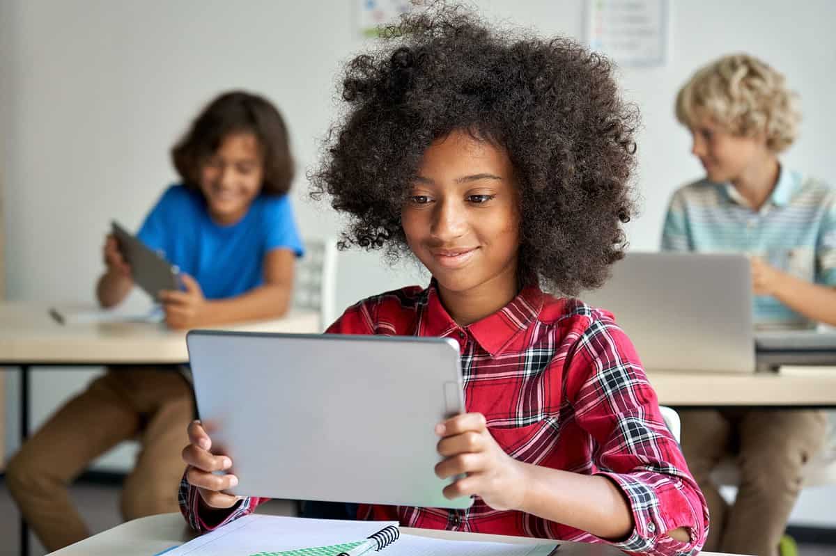 School girl holding device using digital tablet computer