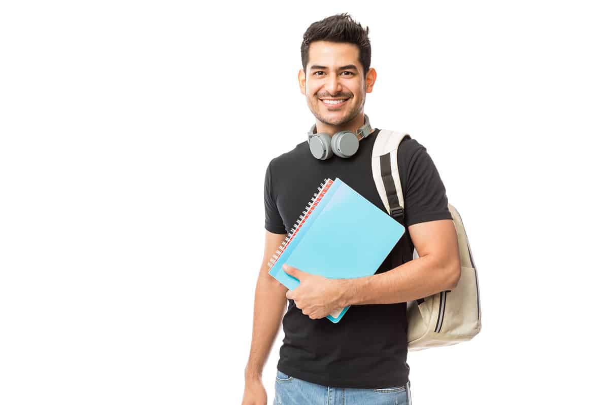 A college student with his backpack looking at the camera.