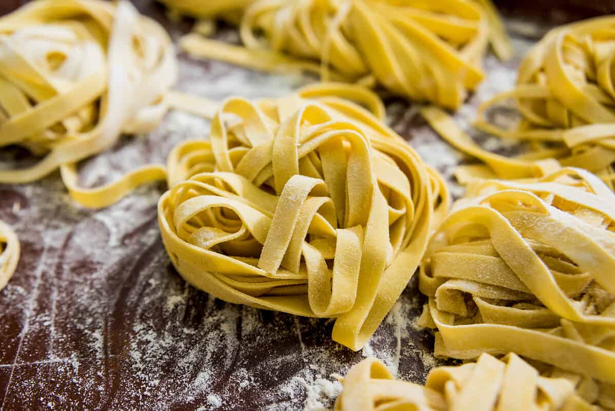 Homemade pasta on a wooden background. Italian style cuisine. Restaurant. Background