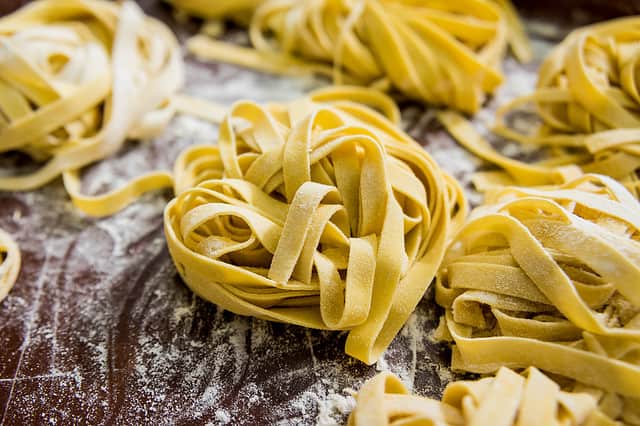 Homemade pasta on a wooden background. Italian style cuisine. Restaurant. Background