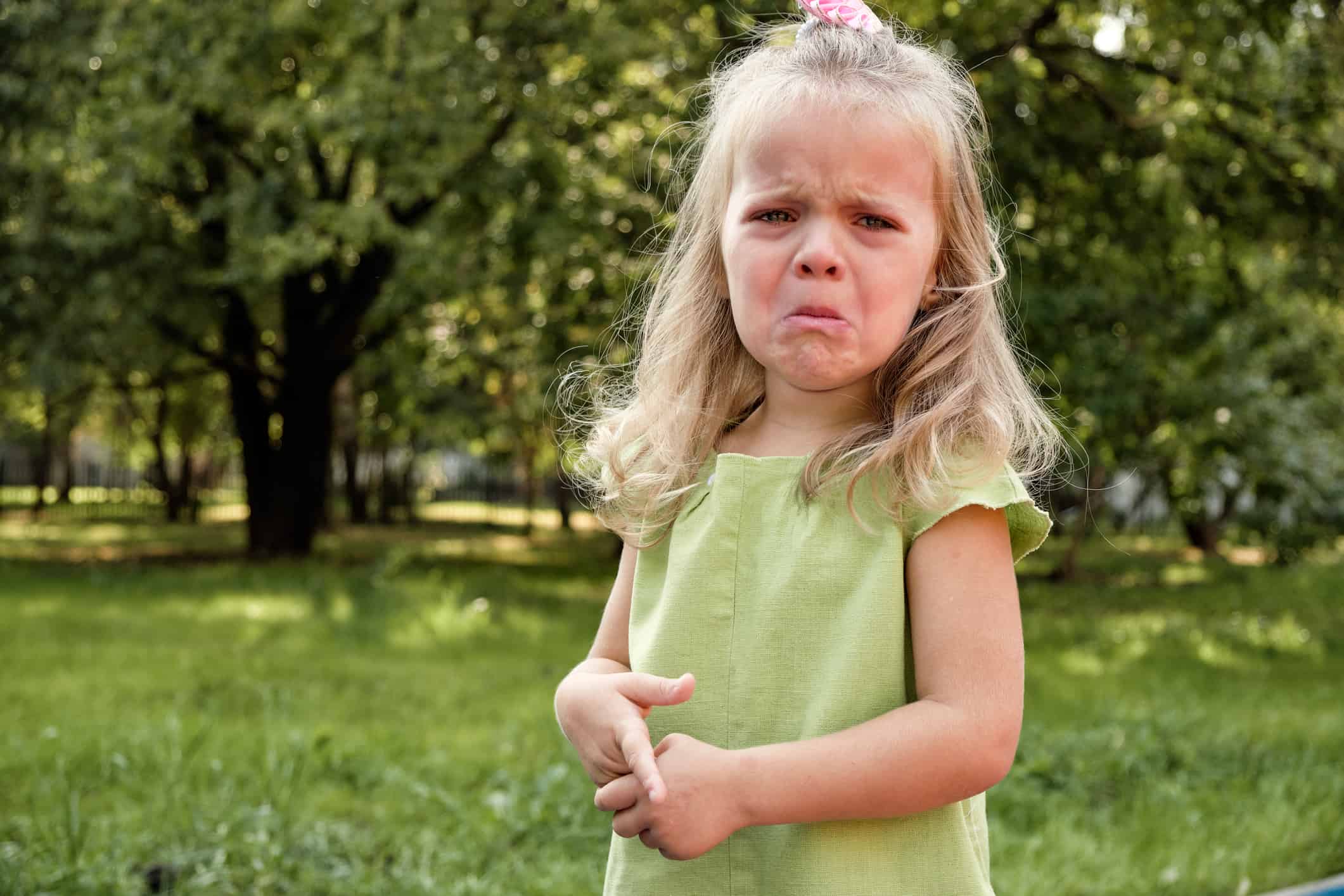 Upset girl child crying in the park