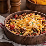Bowl of chili macaroni with cheddar cheese